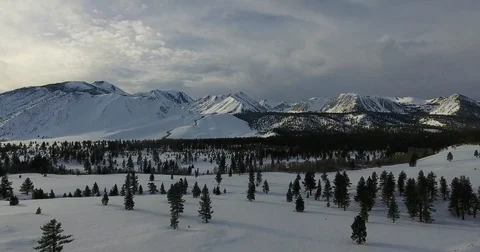 Aerial pullback shot of a snowy valley 4k 24fps Stock Footage 72293562