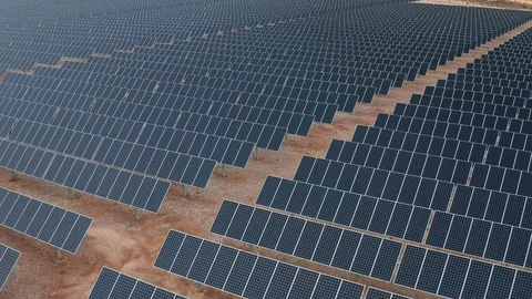Aerial pullback shot of solar panels and photovoltaic cells in desert solar farm Stock Footage 121824028