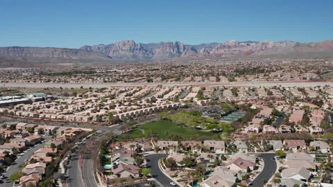 Aerial pullback shot of Summerlin, Las Vegas suburbs with Red Rock Canyon Stock Footage 271202623