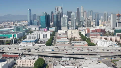Aerial pullback shot of urban Los Angeles downtown, buildings, freeway traffic Stock Footage 273752039