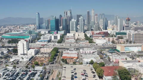 Aerial pullback shot of urban Los Angeles downtown, buildings, cars on freeway Stock Footage 273752315