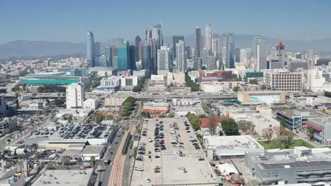Aerial pullback shot of urban Los Angeles downtown, buildings, cars on highway Stock Footage 273752438