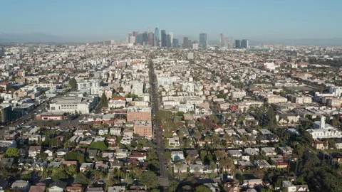 Aerial pullback shot of urban Los Angeles, Koreatown, cars, shops, homes Stock Footage 273756603