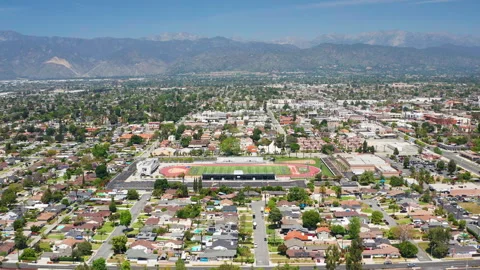 Aerial pullback shot of West Covina suburban Los Angeles California homes Stock Footage 308030661