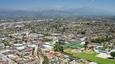 Aerial pullback shot of West Covina suburb Los Angeles California mountain view Stock Footage 308031004