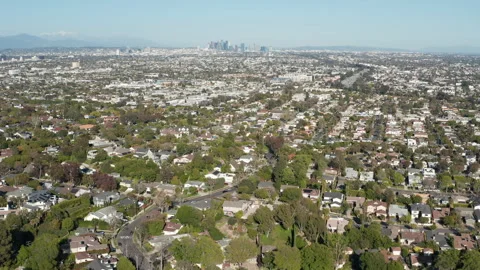 Aerial pullback shot of West Los Angeles and Culver City with downtown skyline Stock Footage 272680124