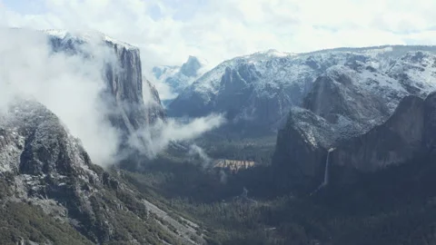 Aerial pullback shot of Yosemite snow mountains, cliffs, valley, and waterfalls Stock Footage 270958239