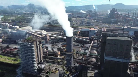 Aerial Pullback from Smoking Industrial Stack Video stock 334903531