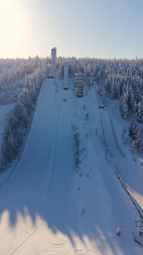 Aerial Pullback Snowy Ski Jumping Ramp in Rovaniemi - Vertical Video Stock Footage 332178998