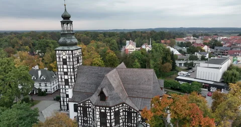 Aerial pullback from St. Andrew Bobola Church in Milicz in autumn Stock Footage 346654766