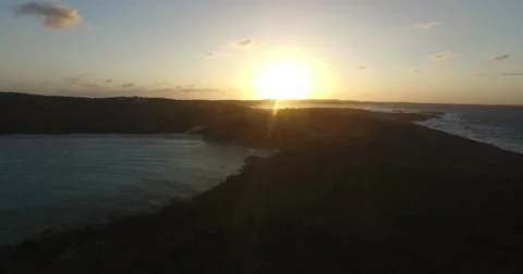 Aerial pullback of the sun setting over Dean's Blue Hole Видео 66317840