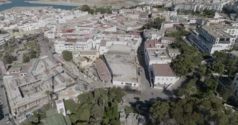 Aerial pullback from Tangier rooftops toward the harbor and city Video stock 347840572