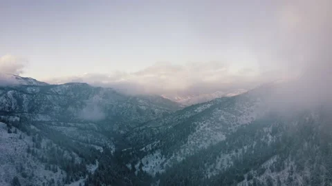 Aerial-Pullback through hazy clouds Shadowy mountain canyon Stock-Footage 143128103