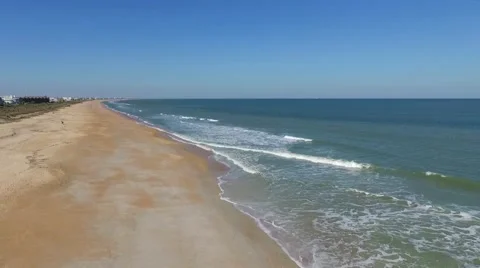 Aerial Pullback Video of Seagulls Sitting in flock Then Flying Over Beach Video stock 62469128