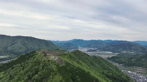 Aerial pullback of view on ancient Takeda Castle ruins in mountains of Hyogo Stock Footage 240158103