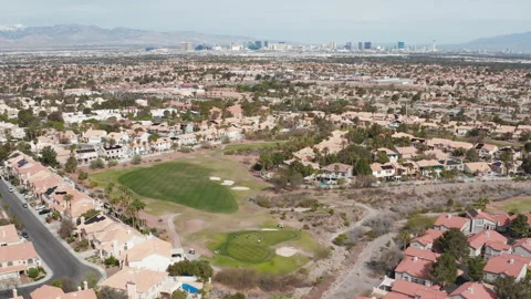 Aerial pullback view of Henderson Las Vegas residence, golf course, and skyline Stock Footage 271303936