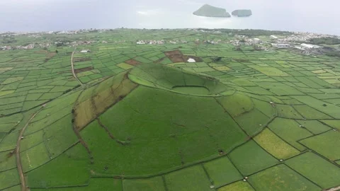 Aerial pullback view of iconic Pico Dona Joana volcanic cone in lush pastureland Stock Footage 296789336