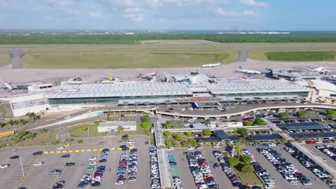 Aerial pullback view of Las Américas International Airport in Punta Stock Footage 233603789