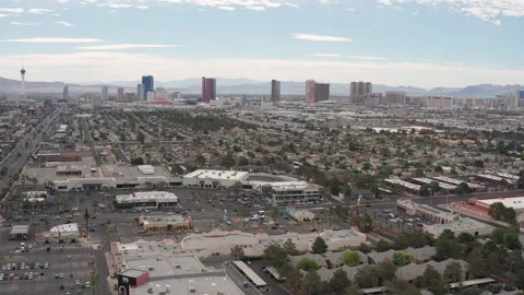 Aerial pullback view Las Vegas commercial stores and shops  with city skyline Stock Footage 197655727
