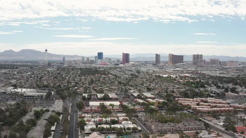 Aerial pullback view of Las Vegas residential houses  with city skyline view Stock Footage 197668471