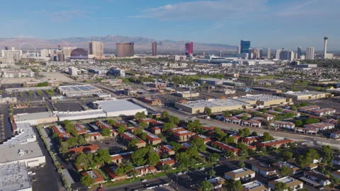 Aerial Pullback View Las Vegas suburbs with Strip skyline and desert mountains Video stock 333485342