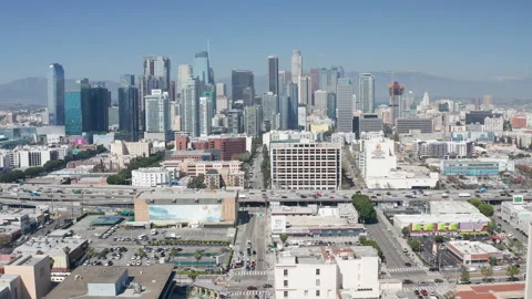Aerial pullback view of Los Angeles downtown buildings and freeway car traffic Stock Footage 273749925