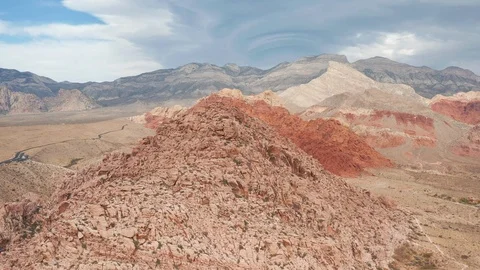 Aerial pullback view of Red Rock Canyon mountain range, peaks, and cliffs Stock Footage 121529066