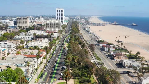 Aerial pullback view of Santa Monica Los Angeles beach coast streets palm trees Stock Footage 308131445