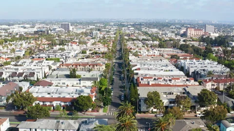 Aerial pullback view of Santa Monica suburb in Los Angeles California palm trees Stock Footage 308198545