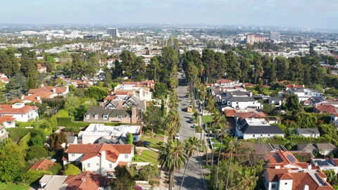 Aerial pullback view of Santa Monica homes in LA suburb with palm trees Stock Footage 308201752