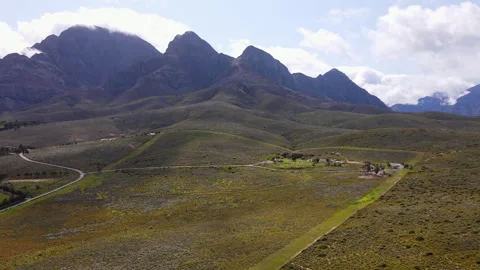 Aerial pullback view of semi-desert biome in Worcester reveals rugged mountains Stock-Footage 300688587