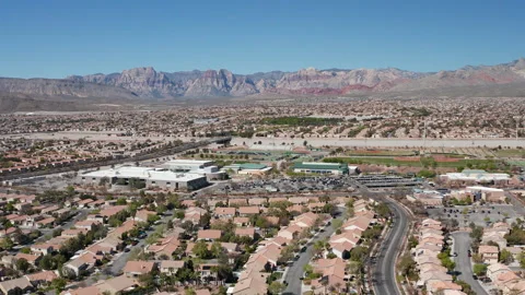 Aerial pullback view of Summerlin Las Vegas with cars driving by and Red Rock Stock Footage 271202864