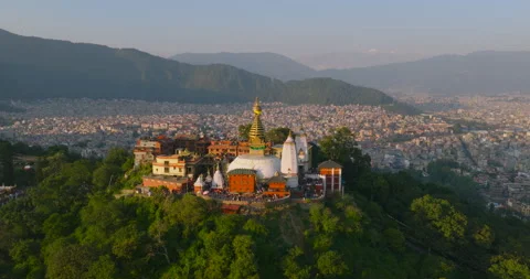Aerial pullback view from Swayambhu stupa revealing Kathmandu valley and hills Video stock 334682823