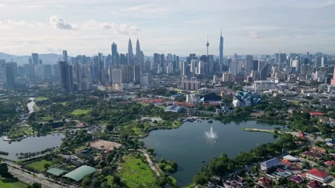 Aerial pullback view Taman Tasik Titiwangsa and KL city Stock Footage 228802899