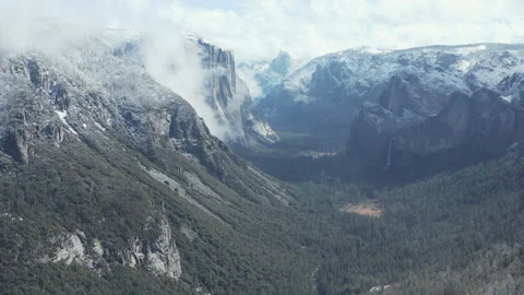 Aerial pullback view of Yosemite snow mountains, cliffs, valley, and waterfalls Stock Footage 270958160