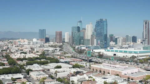 Aerial pullback wide shot of downtown Los Angeles and highway car traffic Stock Footage 273745829