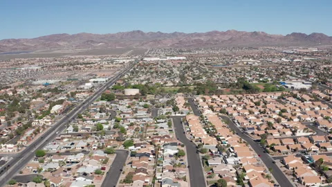 Aerial pullback wide shot of Henderson Nevada with mountains in background Stock Footage 271278593