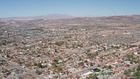 Aerial pullback wide shot of Henderson suburbs in Nevada with mountain range Stock Footage 271279161