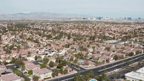 Aerial pullback wide shot of Henderson Las Vegas suburban area with city skyline Stock Footage 271309175