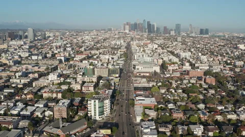 Aerial pullback wide shot of urban Los Angeles, Koreatown, cars, shops, homes Stock Footage 273757282