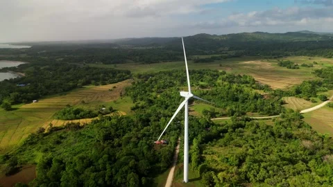 Aerial pullback of wind turbine over green landscape, Guimaras, Philippines Video stock 333771224