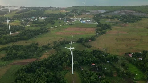 Aerial Pullback of Wind Turbines Across Lush Countryside in Guimaras Stock Footage 332779204