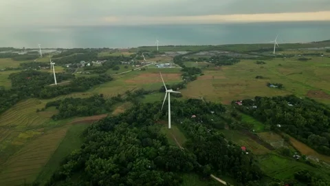 Aerial pullback of wind turbines over lush farmland in San Lorenzo, Guimaras Video stock 333214931