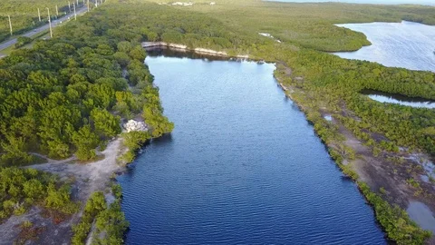 AERIAL: pulling away with a rough rotation to better reveal the water Stockbeeldmateriaal 100450809