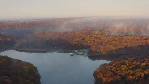 Aerial pulling back from a beautiful river during fall 스톡 동영상 111650009