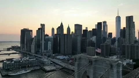 Aerial pulling back close half mast American flag Brooklyn Bridge Manhattan NYC Stock Footage 218058925