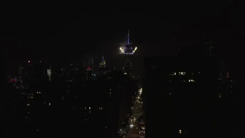 Aerial pulling back Empire State Building fireworks on the 4th of July night NYC Stock Footage 134425177