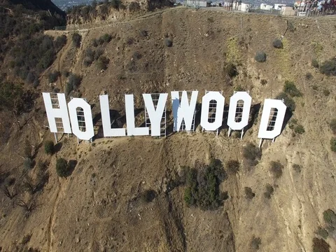 Aerial pulling back from Hollywood sign close-up on hills in Los Angeles 4K Stock Footage 70741592