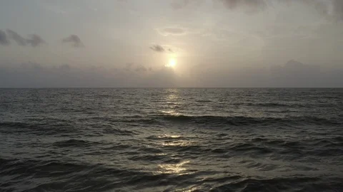 Aerial pulling back low over the crashing waves off of Necocli at sunset 스톡 동영상 108009915