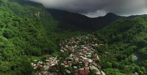 Aerial pulling back out of the entire valley to reveal coastal town under clouds Stock-Footage 70030069